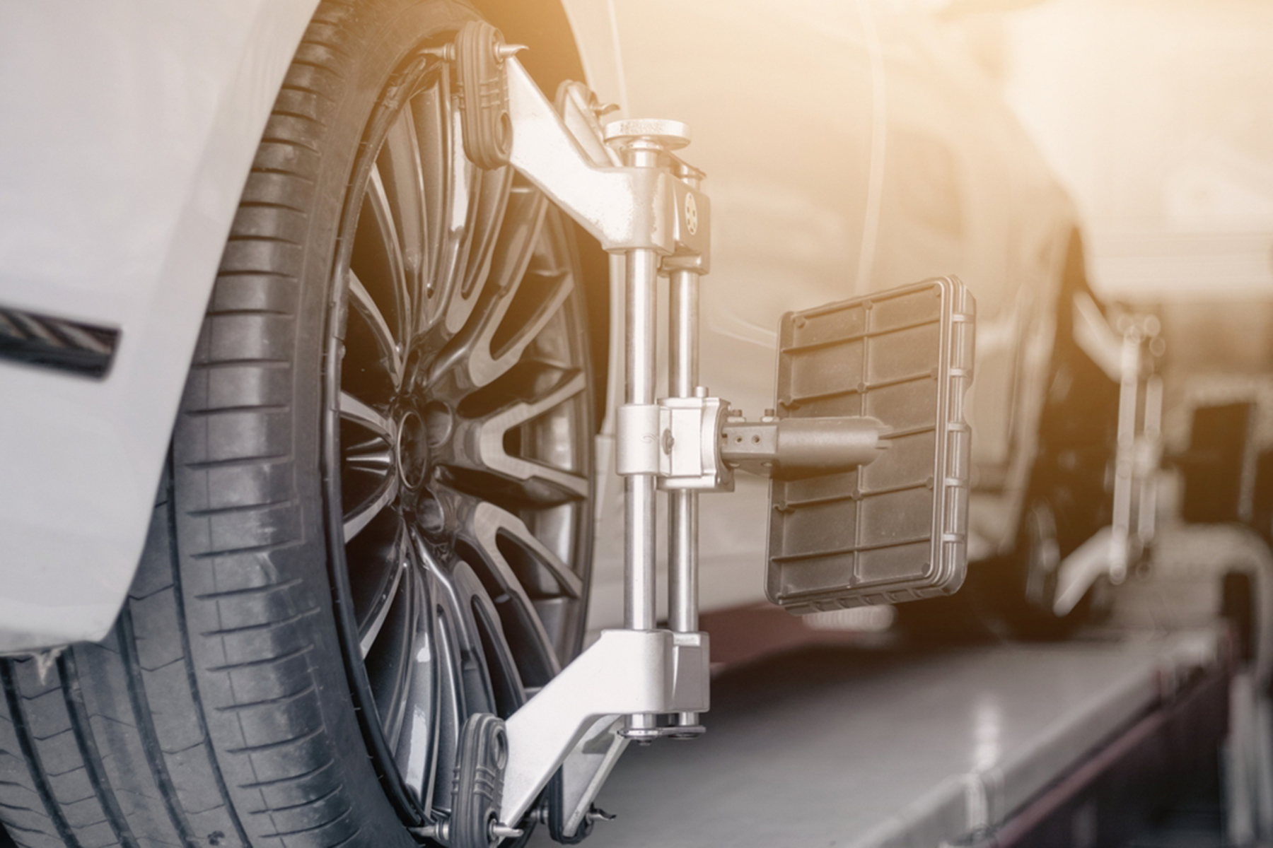 Vehicle wheel alignment. Tyre wheel alignment.Wheel Alignment sensors placed on the tire. Electronic Balance.Car wheel checking in Garage.
